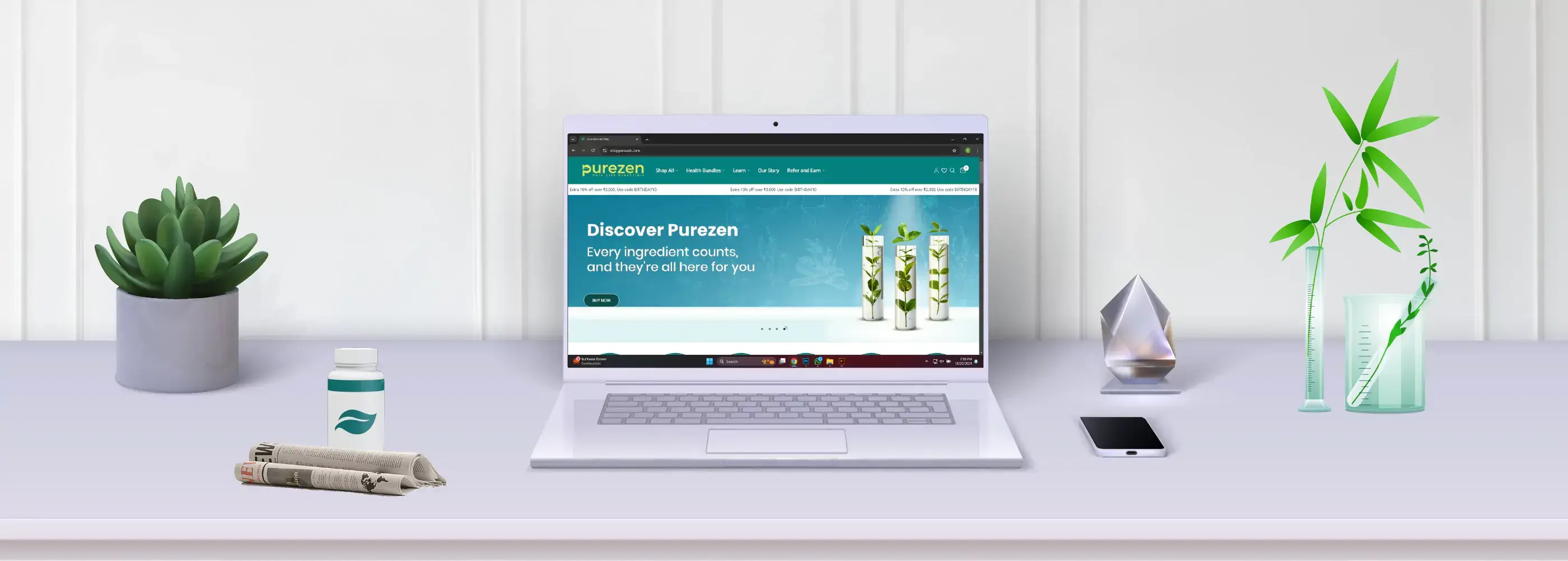 Laptop on a desk with Puravida branding displayed on the screen, surrounded by decorative items.